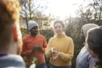 a-multiracial-group-of-volunteers-wearing-warm-casual-clothing-and-accessories-on-a-sunny-cold-winters-day-they-are-talking-before-they-start-working-on-a-community-farm-planting-trees-and-performing–stockpack-gettyimages A multiracial group of volunteers wearing warm casual clothing and accessories on a sunny cold winters day. They are talking before they start working on a community farm, planting trees and performing other tasks.
