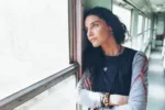 Woman staring out the window struggling with candy flipping